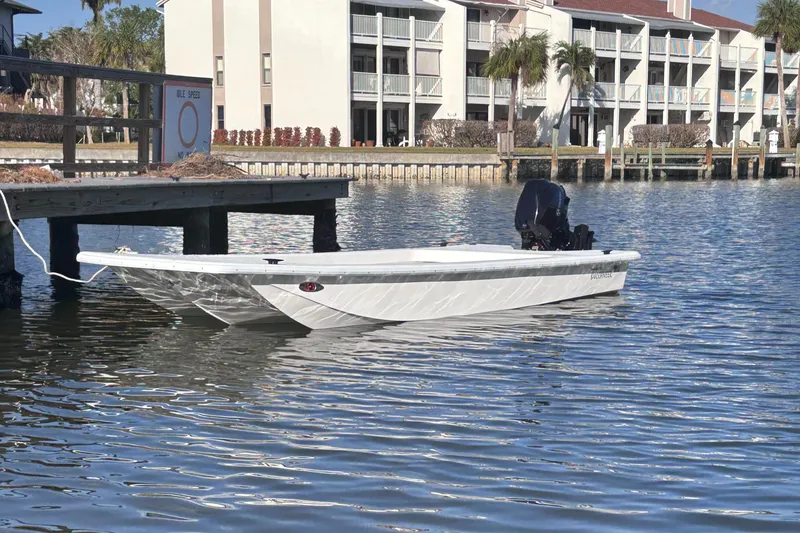 Slide: The Image of 2025 Rabco Buccaneer boat docked on calm water near waterfront buildings. - 0