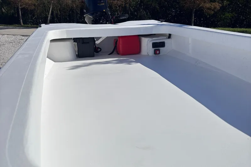 Slide: The Image of 2025 Rabco Buccaneer boat interior with storage compartments and clean white deck. - 3