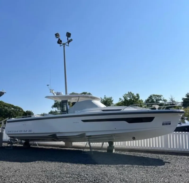 Slide: The Image of 2025 Nimbus Tender 11 boat displayed outdoors under clear blue sky. - 2