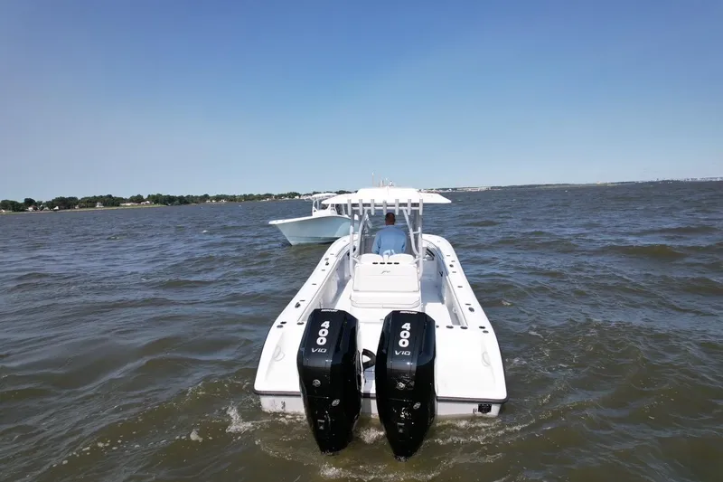 Slide: The Image of 2025 Yellowfin 32 Offshore boat with dual engines on open water. - 12