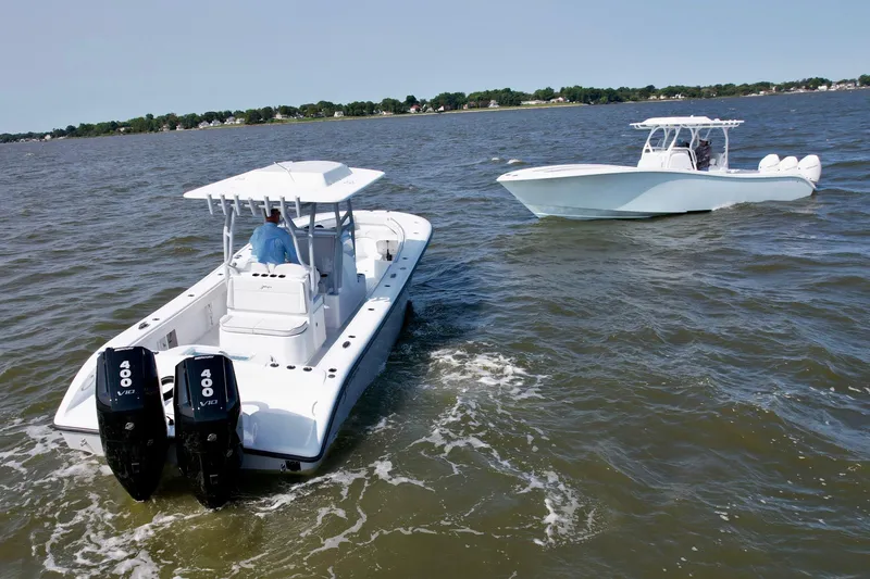 Slide: The Image of 2025 Yellowfin 32 Offshore boats cruising on open water. - 13