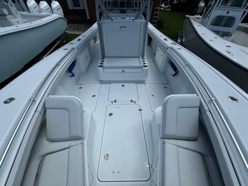 Slide: The Image of 2025 Yellowfin 32 Offshore boat interior with white seating and spacious deck. - 17