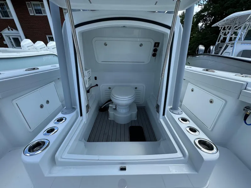 Slide: The Image of 2025 Yellowfin 32 Offshore boat interior with marine toilet and storage compartments. - 19