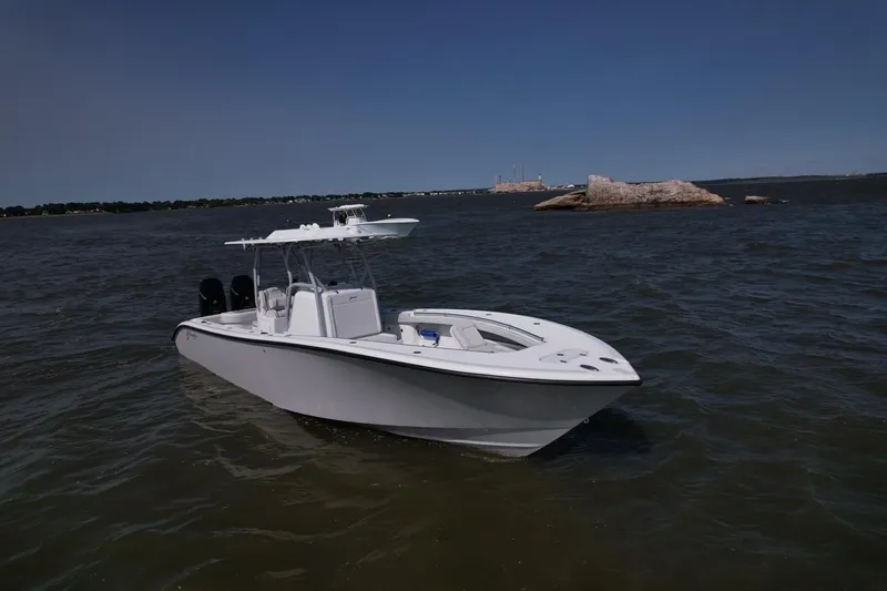 Slide: The Image of 2025 Yellowfin 32 Offshore boat on open water, clear sky background. - 2