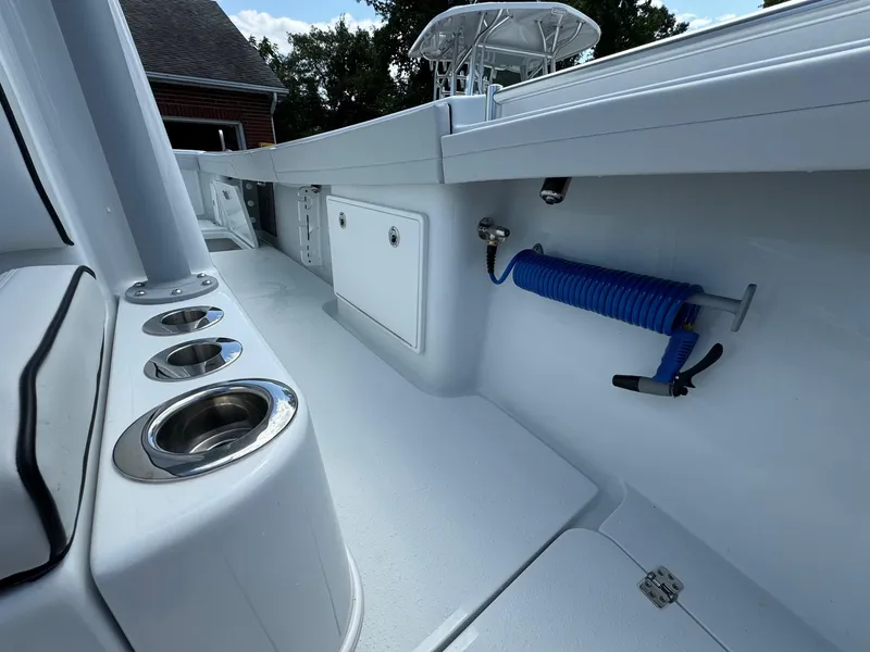 Slide: The Image of 2025 Yellowfin 32 Offshore boat interior with rod holders and storage compartments. - 20