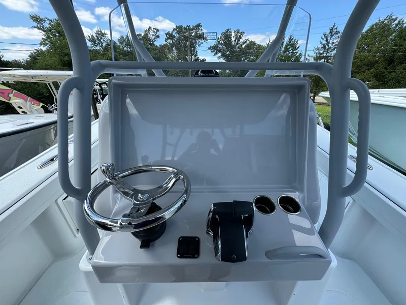 Slide: The Image of 2025 Yellowfin 32 Offshore boat helm with steering wheel and controls. - 24