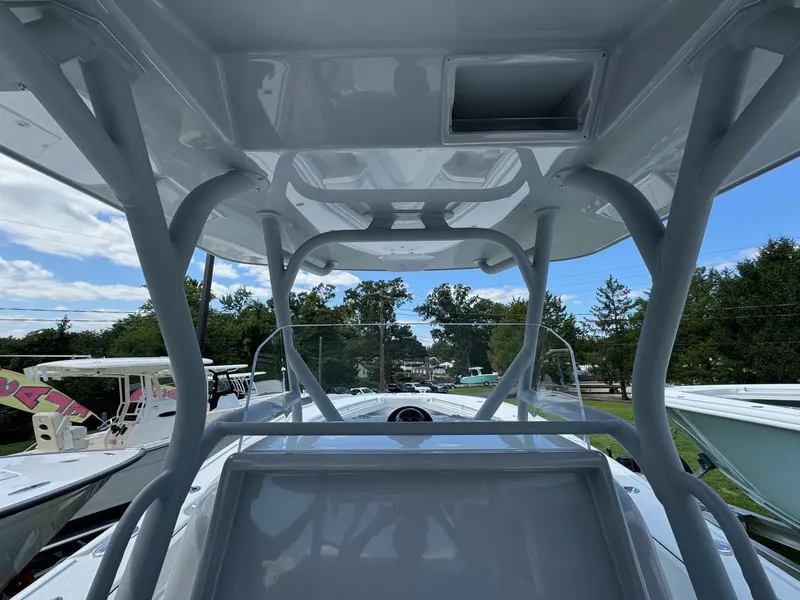 Slide: The Image of 2025 Yellowfin 32 Offshore boat interior with T-top and console view. - 25