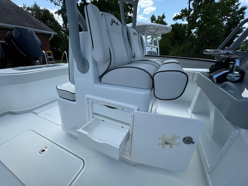 Slide: The Image of 2025 Yellowfin 32 Offshore boat interior with white seating and storage compartments. - 29