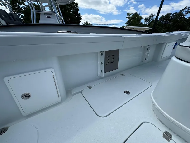 Slide: The Image of 2025 Yellowfin 32 Offshore boat interior with storage compartments. - 31