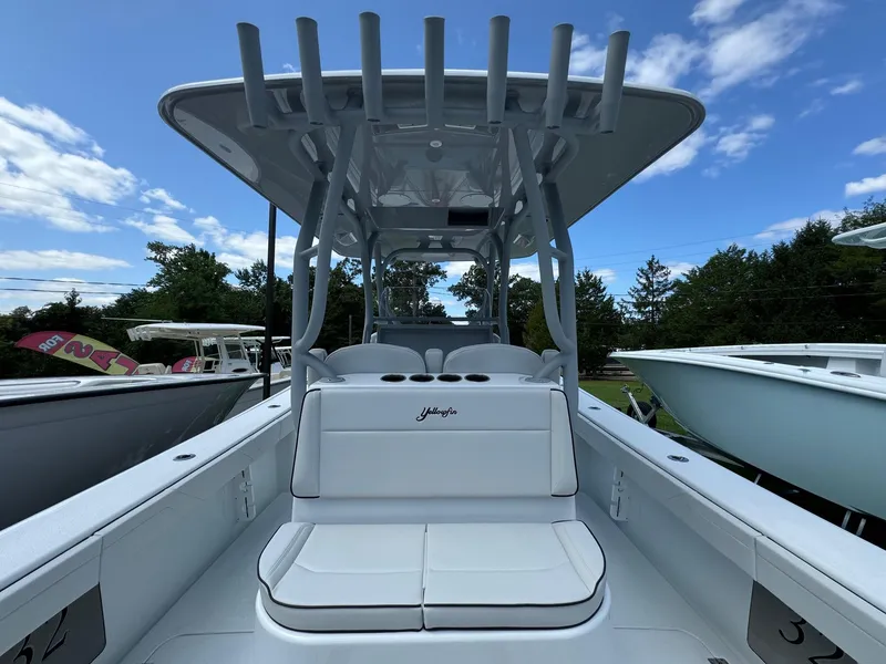 Slide: The Image of 2025 Yellowfin 32 Offshore boat with seating and T-top under a blue sky. - 32