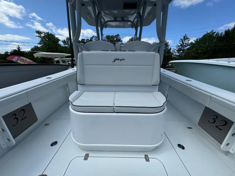 Slide: The Image of 2025 Yellowfin 32 Offshore boat interior with white seating and open deck. - 33