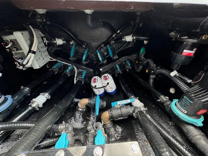 Slide: The Image of 2025 Yellowfin 32 Offshore boat engine compartment with wiring and components. - 37