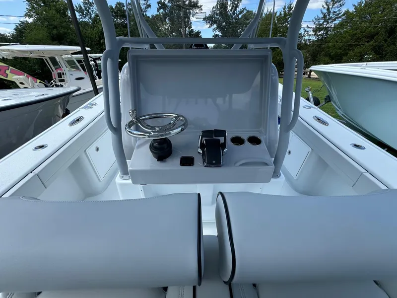 Slide: The Image of 2025 Yellowfin 32 Offshore boat cockpit with steering wheel and controls. - 39