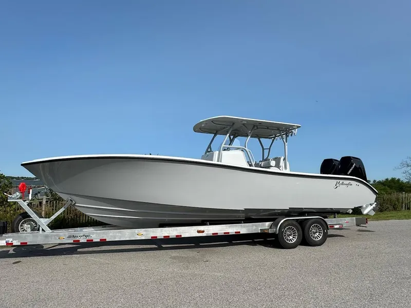 Slide: The Image of 2025 Yellowfin 32 Offshore boat on trailer, side view, clear sky background. - 5