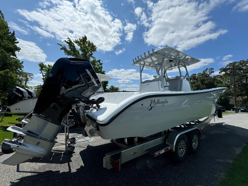 Slide: The Image of 2025 Yellowfin 32 Offshore boat on trailer under blue sky. - 7