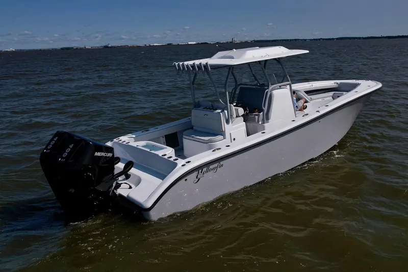 Slide: The Image of 2025 Yellowfin 32 Offshore boat on calm water, featuring sleek design and powerful engine. - 8