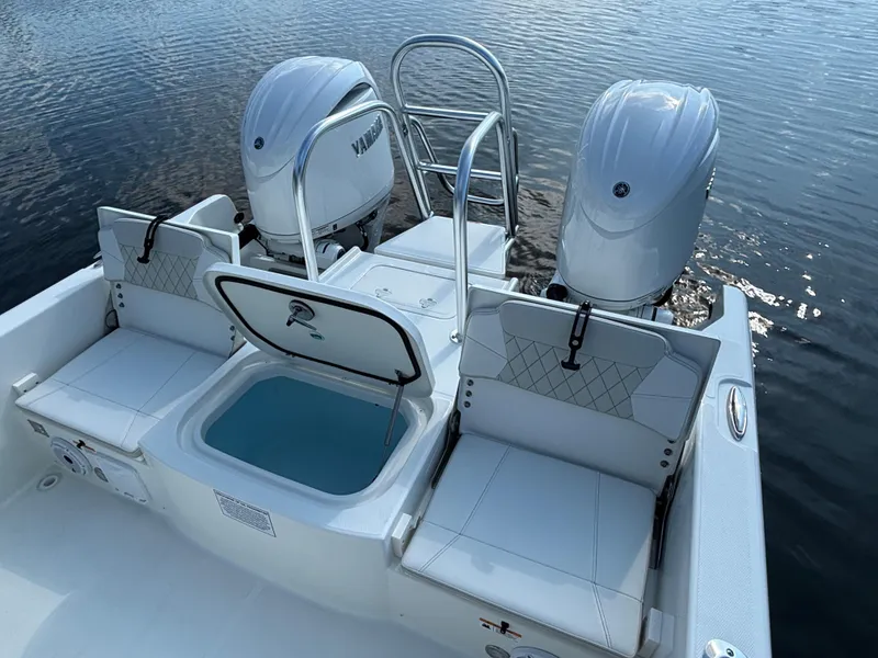 Slide: The Image of 2025 World Cat 235 CC boat with twin engines and open storage compartment. - 8