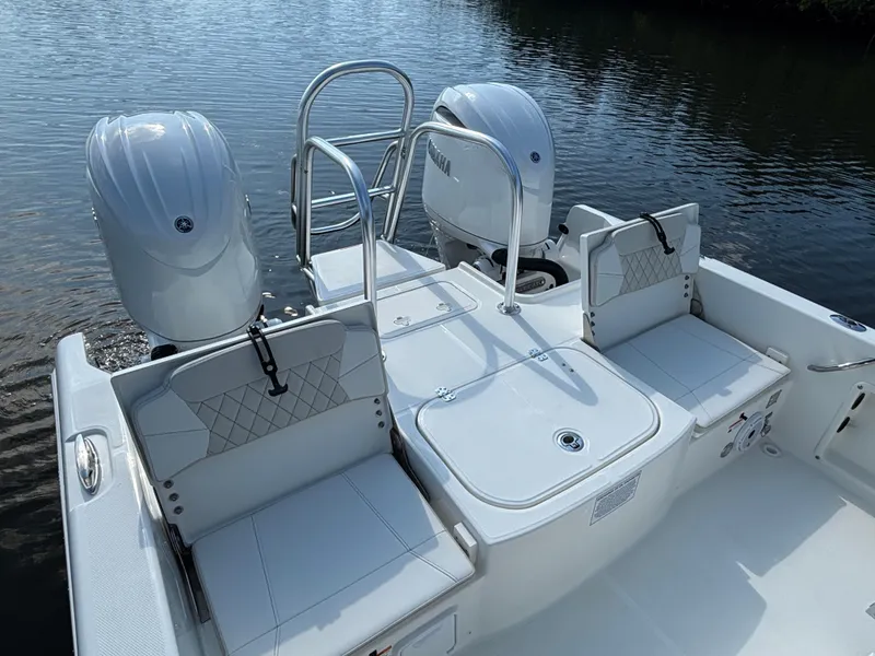 Slide: The Image of 2025 World Cat 235 CC boat with dual engines on calm water. - 9