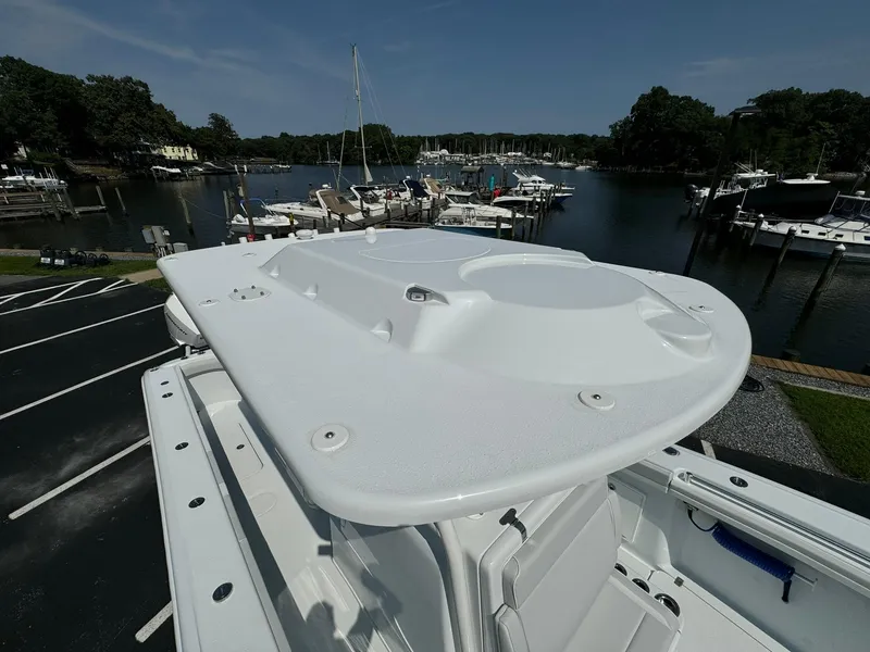 Slide: The Image of 2025 Yellowfin 34 Offshore boat docked at a marina, showcasing its sleek design. - 14