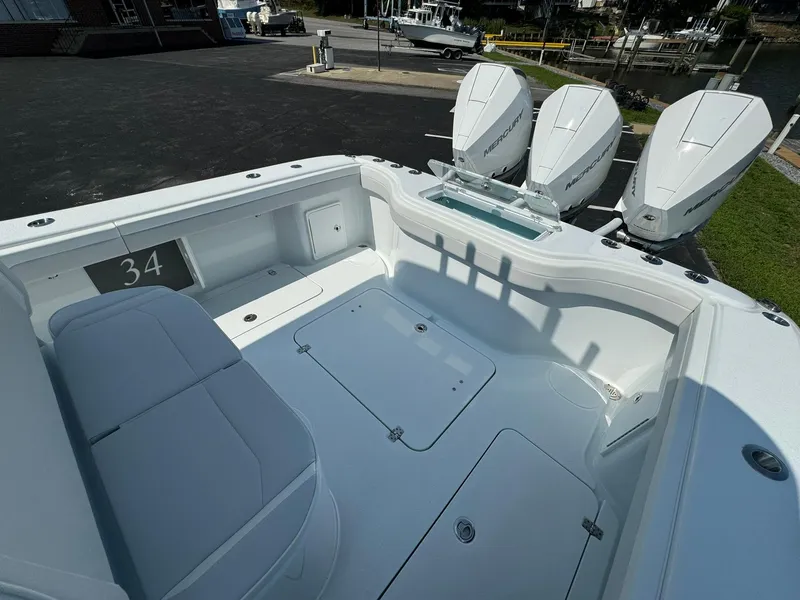 Slide: The Image of 2025 Yellowfin 34 Offshore boat with triple outboard engines, spacious deck area. - 23