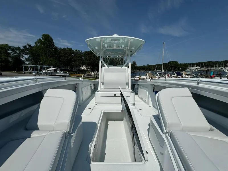 Slide: The Image of 2025 Yellowfin 34 Offshore boat with spacious seating and storage, docked at a marina. - 35