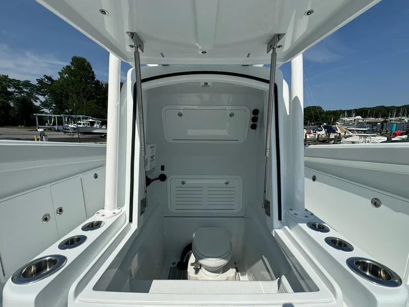 Slide: The Image of 2025 Yellowfin 34 Offshore boat interior with marine toilet and storage. - 36
