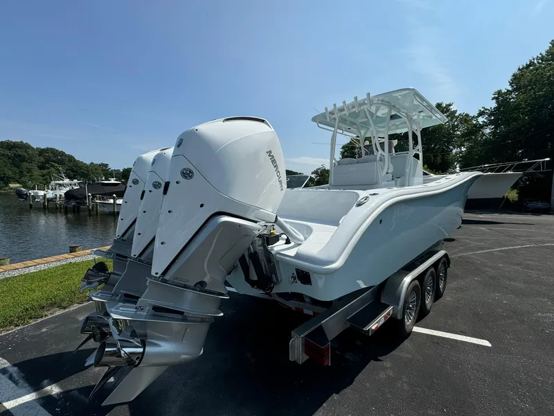 Slide: The Image of 2025 Yellowfin 34 Offshore boat with triple outboard engines on trailer. - 4