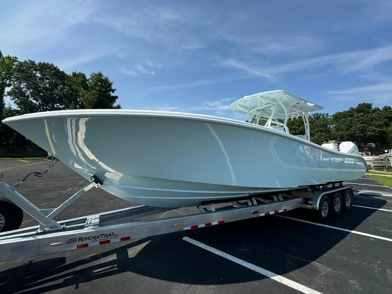 Slide: The Image of 2025 Yellowfin 34 Offshore boat on trailer, parked outdoors under clear sky. - 8