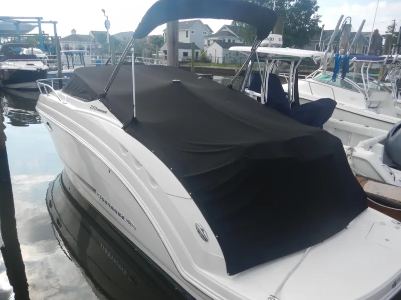 Slide: The Image of 2017 Chaparral 270 Signature boat with black cover docked at marina. - 10