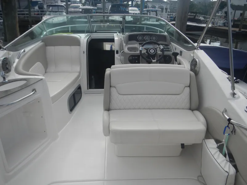Slide: The Image of 2017 Chaparral 270 Signature boat interior with white seating and modern dashboard. - 13