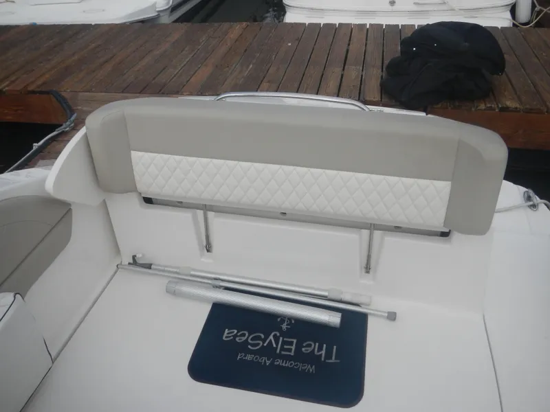 Slide: The Image of 2017 Chaparral 270 Signature boat interior with cushioned seating and dock view. - 18