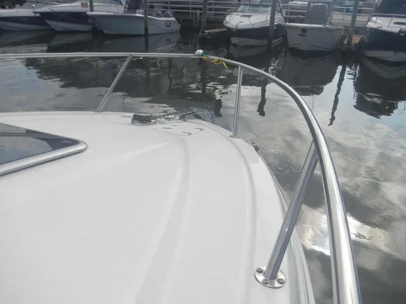 Slide: The Image of 2017 Chaparral 270 Signature boat docked at marina, view from bow. - 28