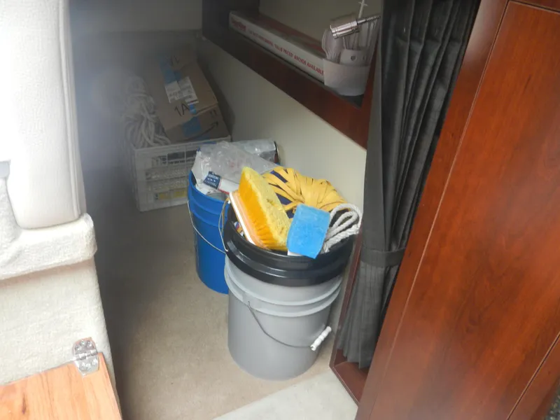 Slide: The Image of Interior storage area of 2017 Chaparral 270 Signature boat with cleaning supplies. - 30