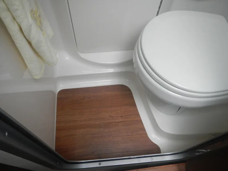 Slide: The Image of 2017 Chaparral 270 Signature bathroom with wooden flooring and white toilet. - 31