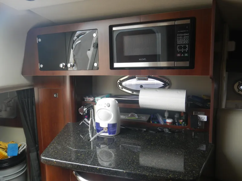 Slide: The Image of 2017 Chaparral 270 Signature boat kitchen with microwave and countertop appliances. - 36