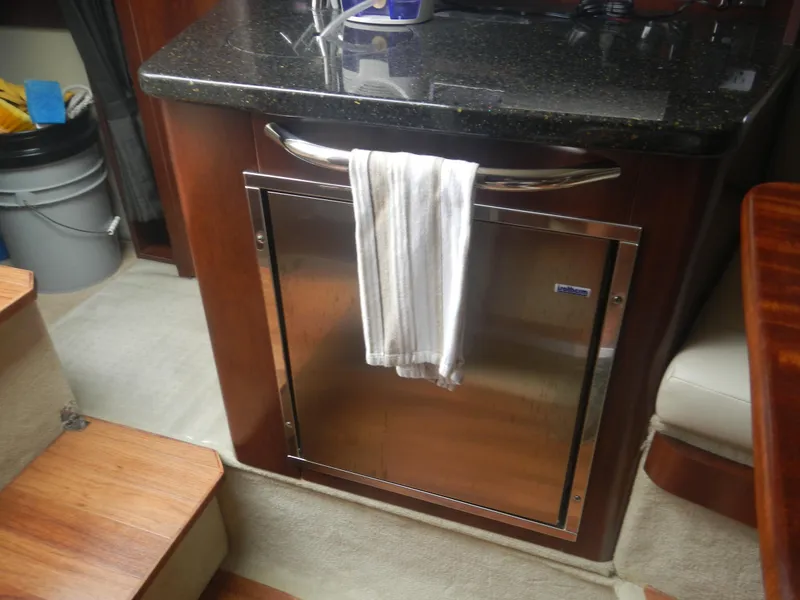 Slide: The Image of 2017 Chaparral 270 Signature interior with kitchenette and stainless steel fridge. - 37