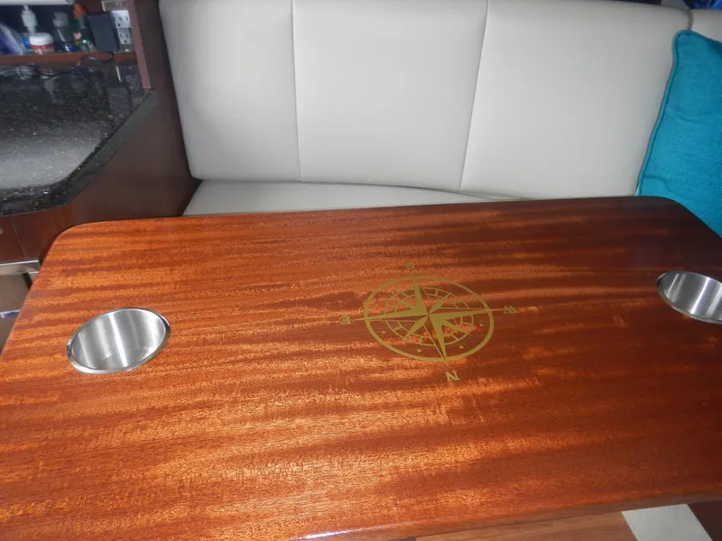 Slide: The Image of Wooden table with compass design in 2017 Chaparral 270 Signature boat interior. - 38