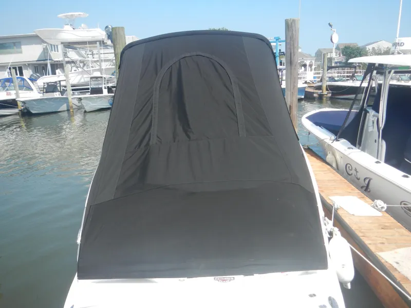 Slide: The Image of 2017 Chaparral 270 Signature boat with black cover docked at marina. - 4