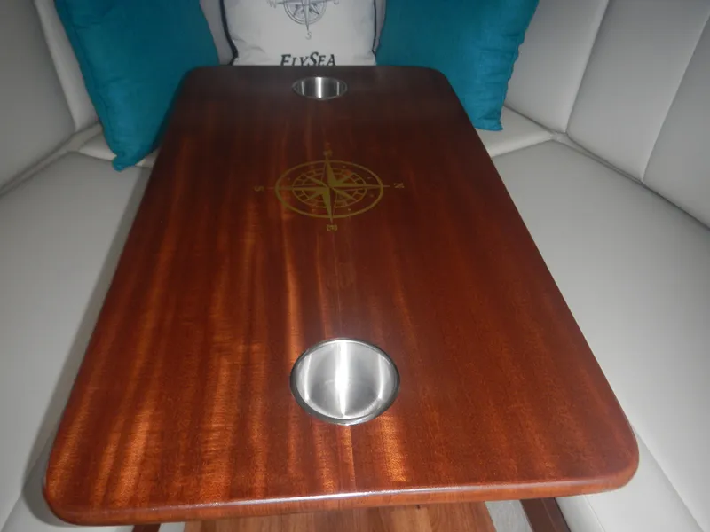 Slide: The Image of Wooden table with compass design in Chaparral 270 Signature, 2017 model, featuring cup holders. - 41