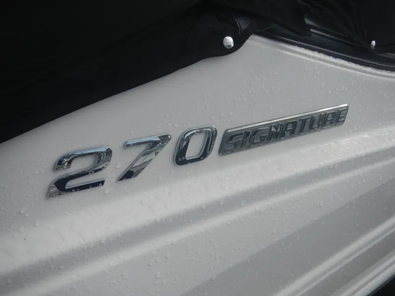 Slide: The Image of 2017 Chaparral 270 Signature boat emblem with raindrops on white surface. - 42