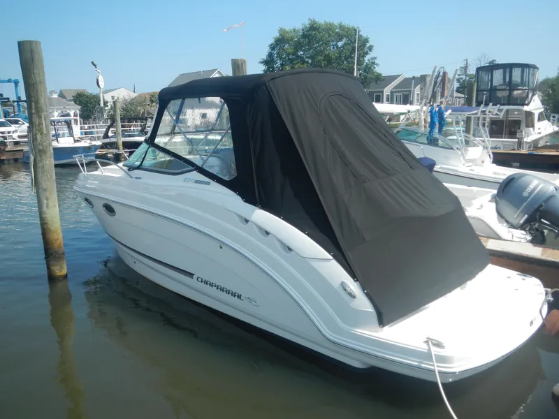 Slide: The Image of 2017 Chaparral 270 Signature boat docked with black canopy in marina. - 5