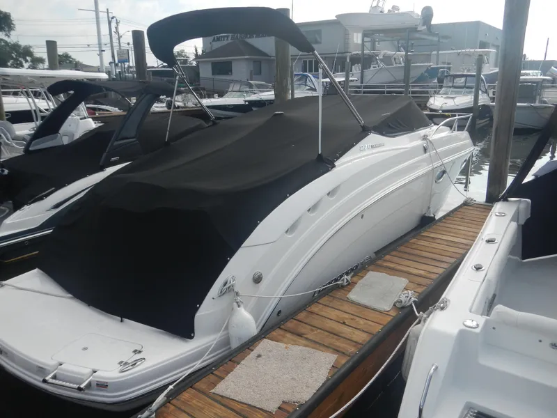 Slide: The Image of 2017 Chaparral 270 Signature boat docked with black cover. - 7