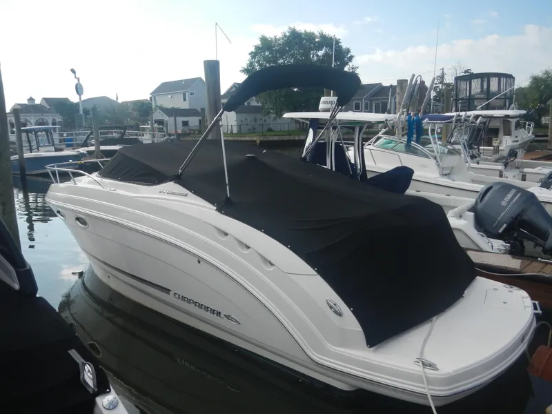 Slide: The Image of 2017 Chaparral 270 Signature boat docked with black cover. - 9