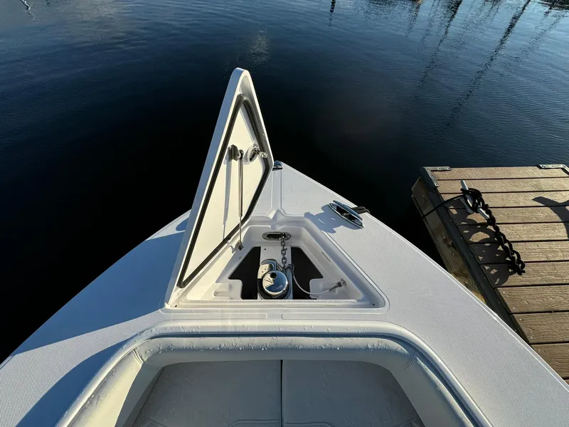 Slide: The Image of 2024 Jupiter 26 FS boat bow with open storage compartment by the dock. - 11