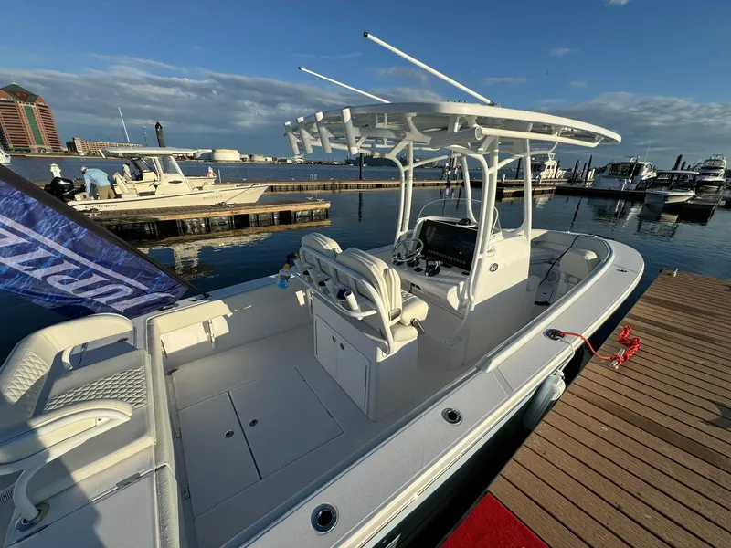 Slide: The Image of 2024 Jupiter 26 FS boat docked at marina under clear sky. - 21