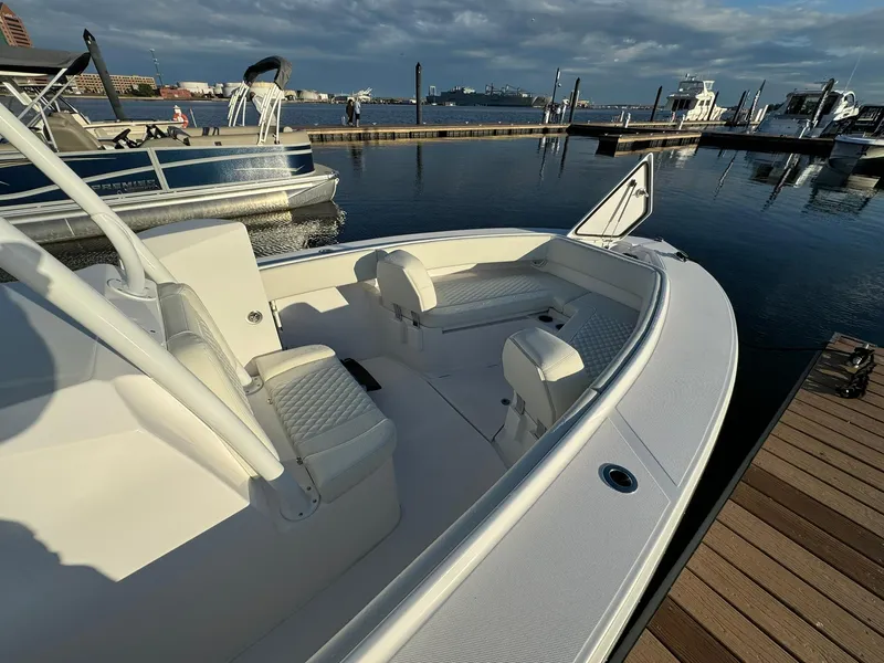 Slide: The Image of 2024 Jupiter 26 FS boat docked at marina under cloudy sky. - 6