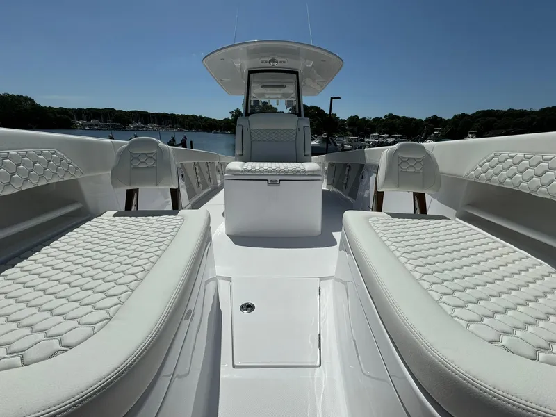 Slide: The Image of 2024 Jupiter 340LS boat interior with luxurious white seating and sleek design. - 18