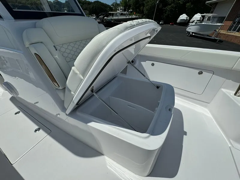 Slide: The Image of 2024 Jupiter 340LS boat with open storage compartment and white seating. - 20