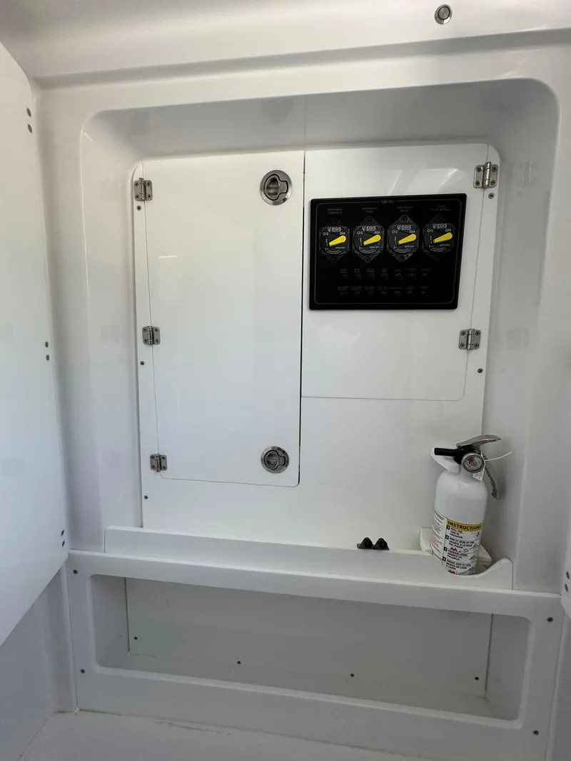 Slide: The Image of 2024 Jupiter 340LS boat interior with control panel and fire extinguisher. - 24