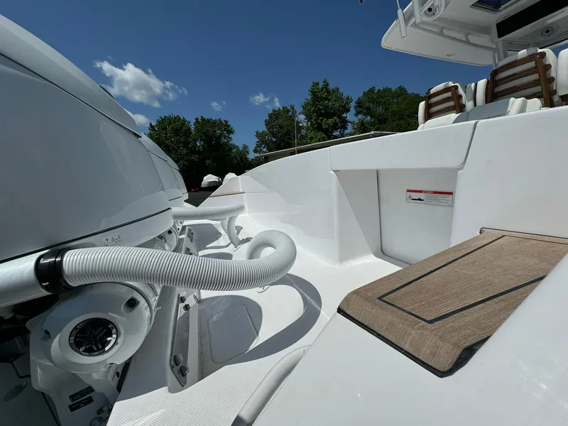 Slide: The Image of 2024 Jupiter 340LS boat deck with seating, under a clear blue sky. - 34